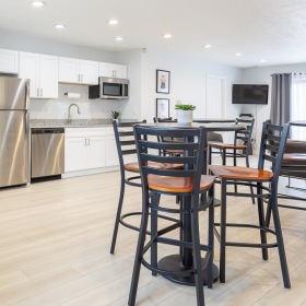 Room with tall tables and kitchen